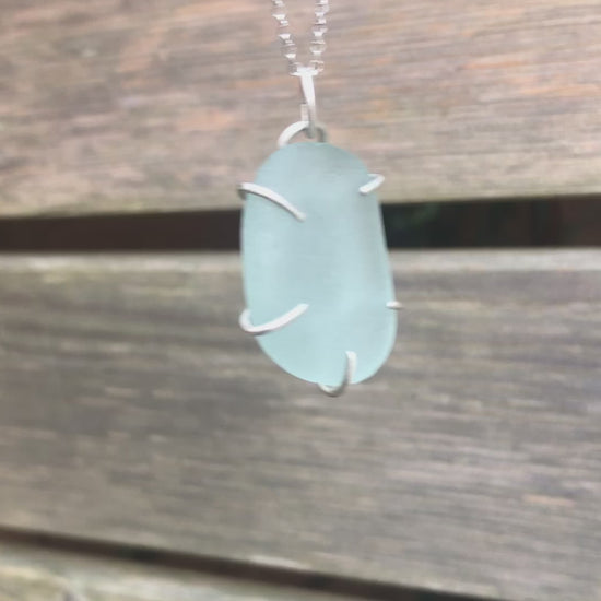 Handcrafted sterling silver pendant with luminous aqua genuine sea glass in a claw setting, eco-friendly and unique handmade ocean-inspired jewellery. Relic Jewellery UK
